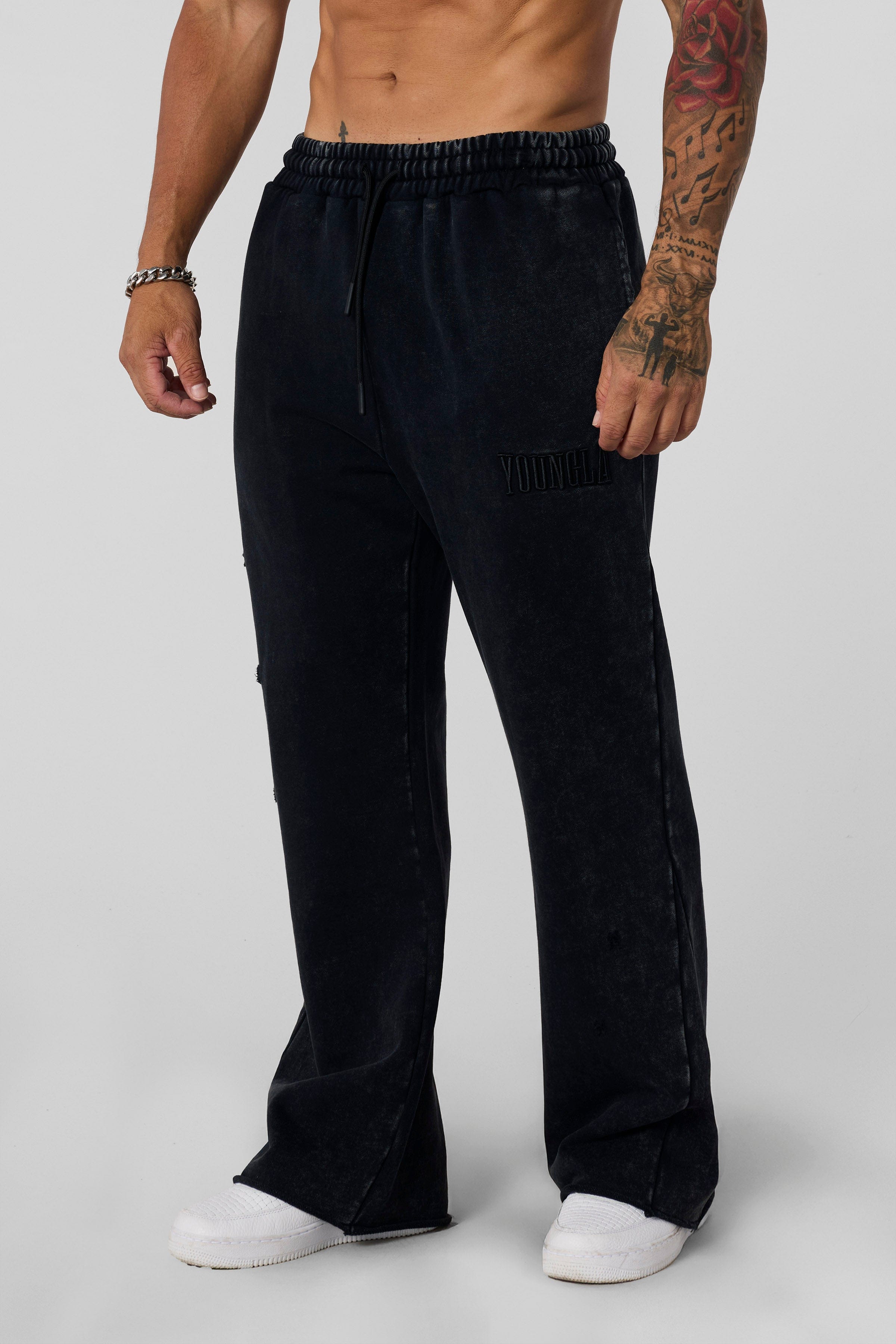 2077 - Flare Sweats - Heavyweight fleece sweats with structure and warmth. Minimal branding and clean lines create a bold, everyday-ready silhouette in Black Wash.