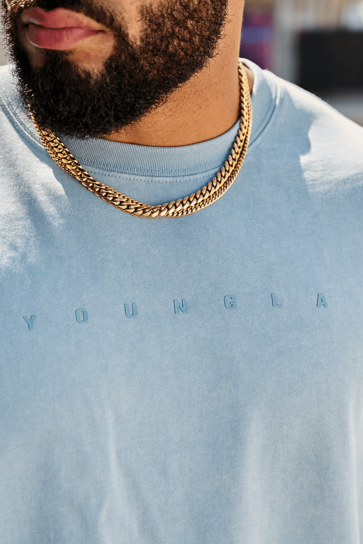 4219 - Summer Peached Tees for Men: 100% cotton garment-washed tee with buttery-soft hand feel, smooth drape, laid-back fit, and perfect for everyday layering in color Light blue wash- Close shot.